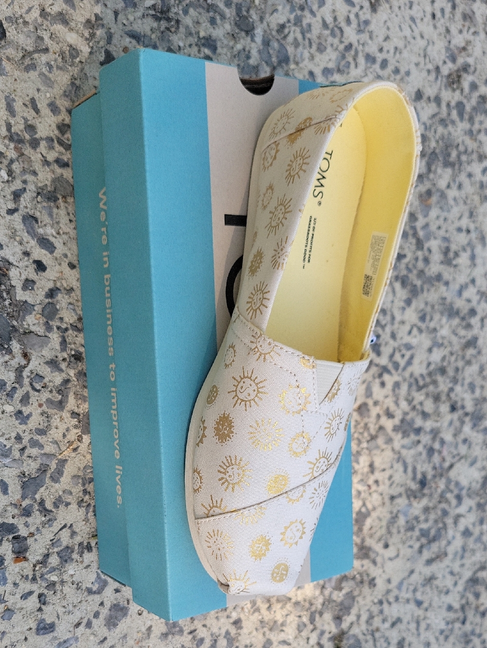 Toms Women's Cream Slip-On with Gold Sunburst Accents